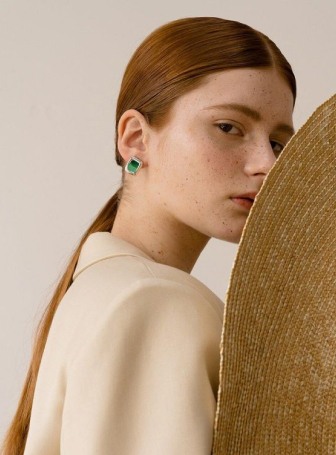 Person wearing green earrings